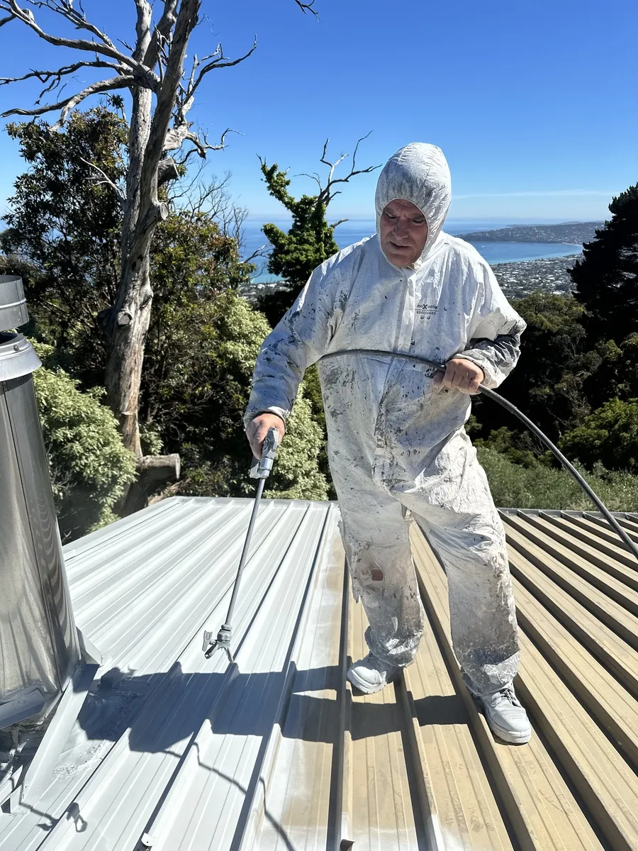 Exterior spray painting in action